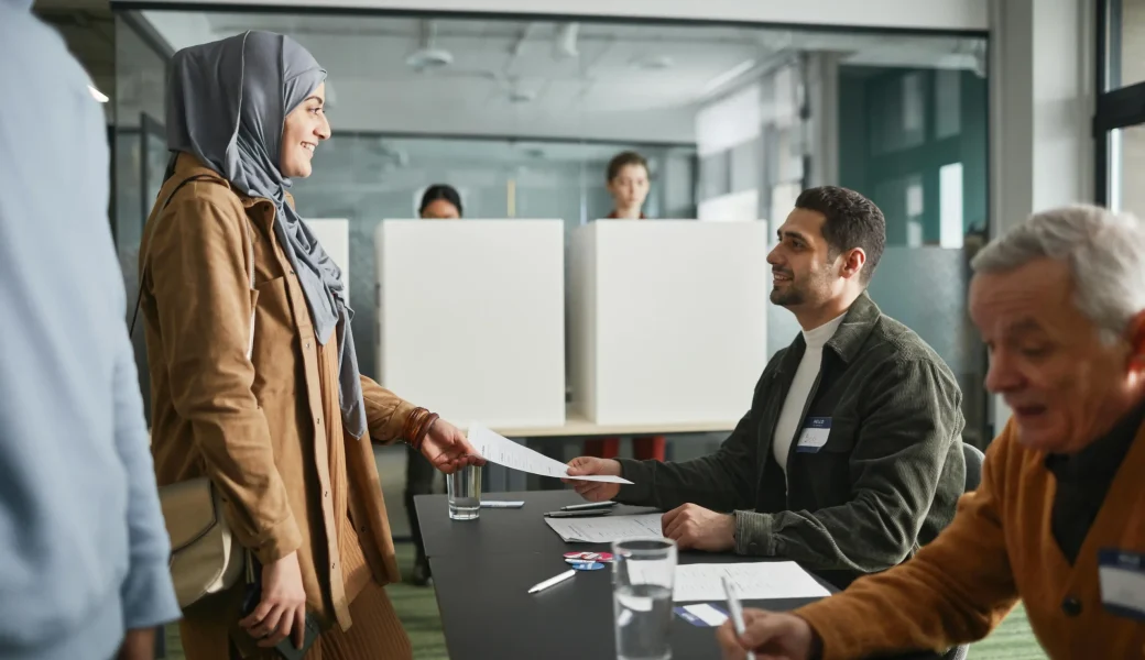 A woman submitting documents to a notary officer, representing a legal notarization process — ideal for illustrating /public-vs-private-notary-dubai comparison.